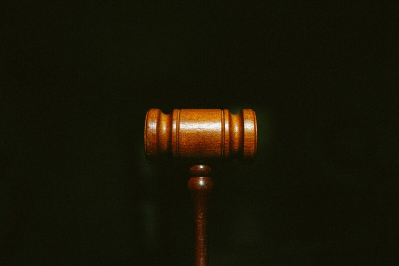 A gavel set on a black background
