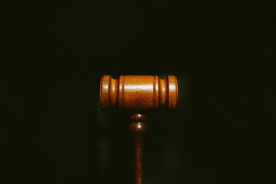 A gavel set on a black background
