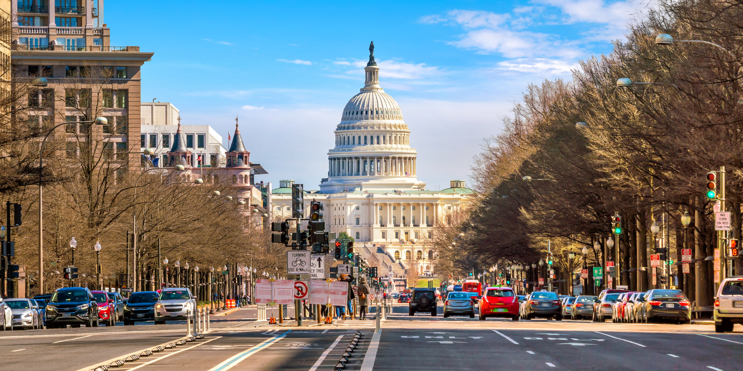 Cars driving on a street in Washington, D.C. The street dead ends at the U.S. Capitol.