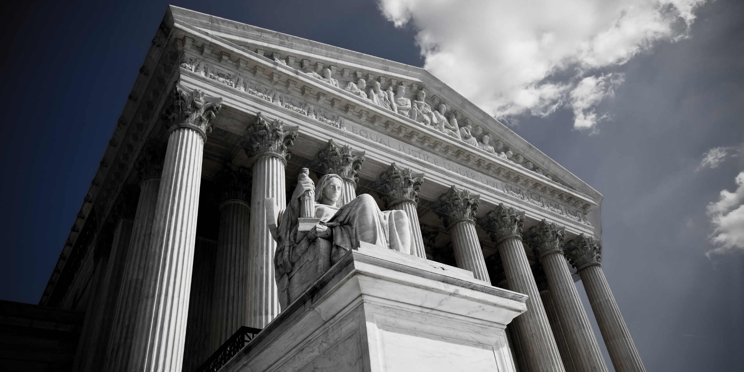A dark photo of the outside of the U.S. Supreme Court.