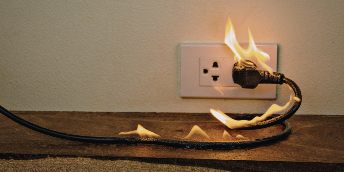 A cord catching fire while plugged into an outlet.