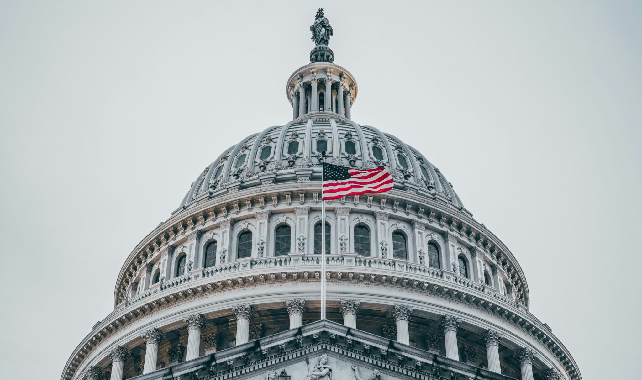 Close-up of the U.S. Capitol with a centered American flag